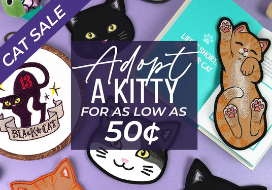 Machine embroidered cat designs - bookmark, coaster, and design in hoop with text "Cat sale - adopt a kitty for as low as 50 cents"