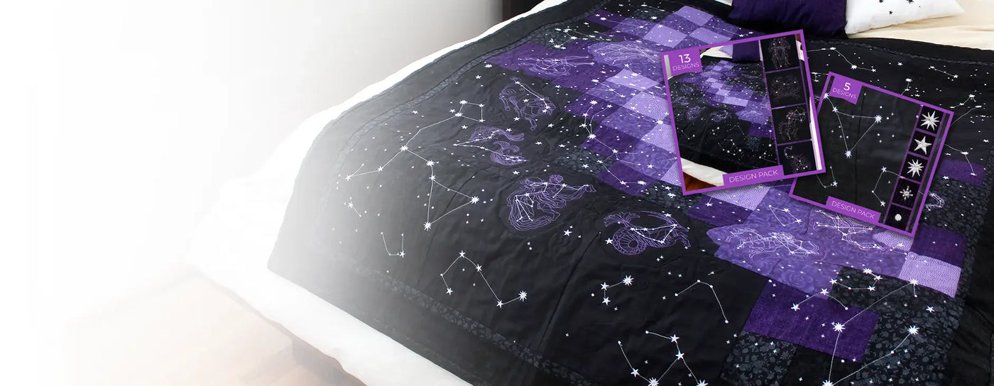 Machine Embroidered celestial quilt using zodiac and constellation designs on black and purple fabric.