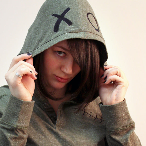 Close-up of a hoodie hood embroidered with large “XO” letters; digitally downloadable machine embroidery design.