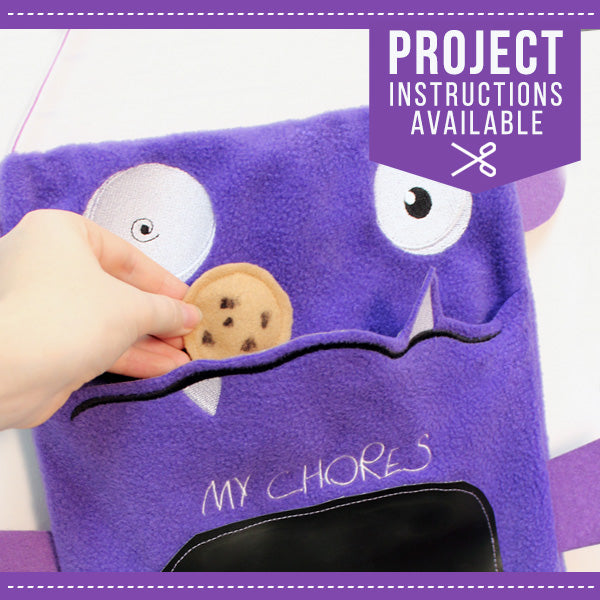 A purple felt pocket is embroidered with “MY CHORES” and features Monster Factory details; hand and cookie also visible.