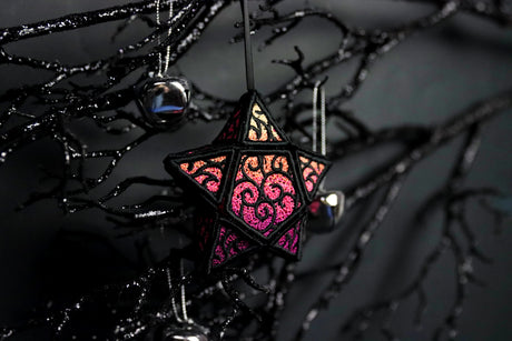 machine embroidered 3D Lace star hanging on dark branches surrounded by bells