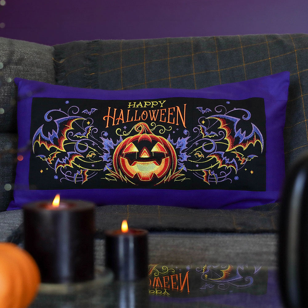 Embroidered Halloween scene with jack-o-lanterns and bats, shown as a digitally downloadable machine embroidery design.