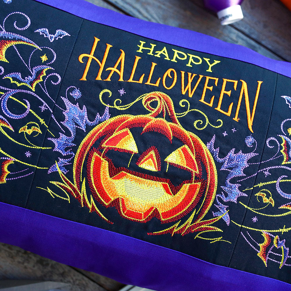 Digitally downloadable machine embroidery design of Jack o Lanterns, bats, and swirling accents stitched in festive detail.