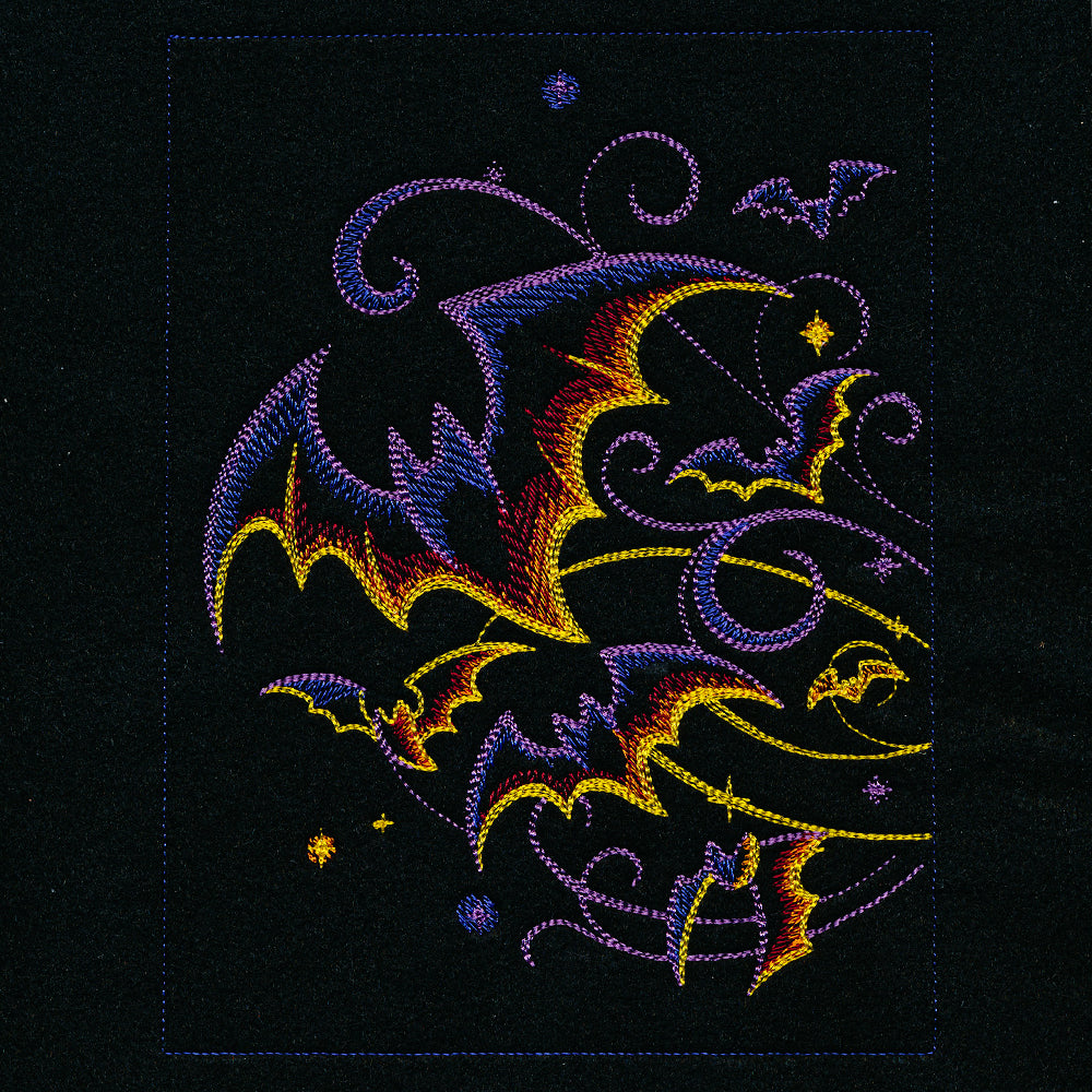 Digitally downloadable machine embroidery design with a jack-o-lantern, colorful bats, swirling lines, and star motifs.