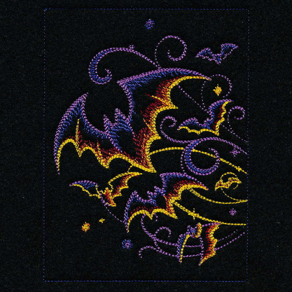 Embroidered bats, crescent moons, and stars on black fabric shown in a digitally downloadable machine embroidery design.