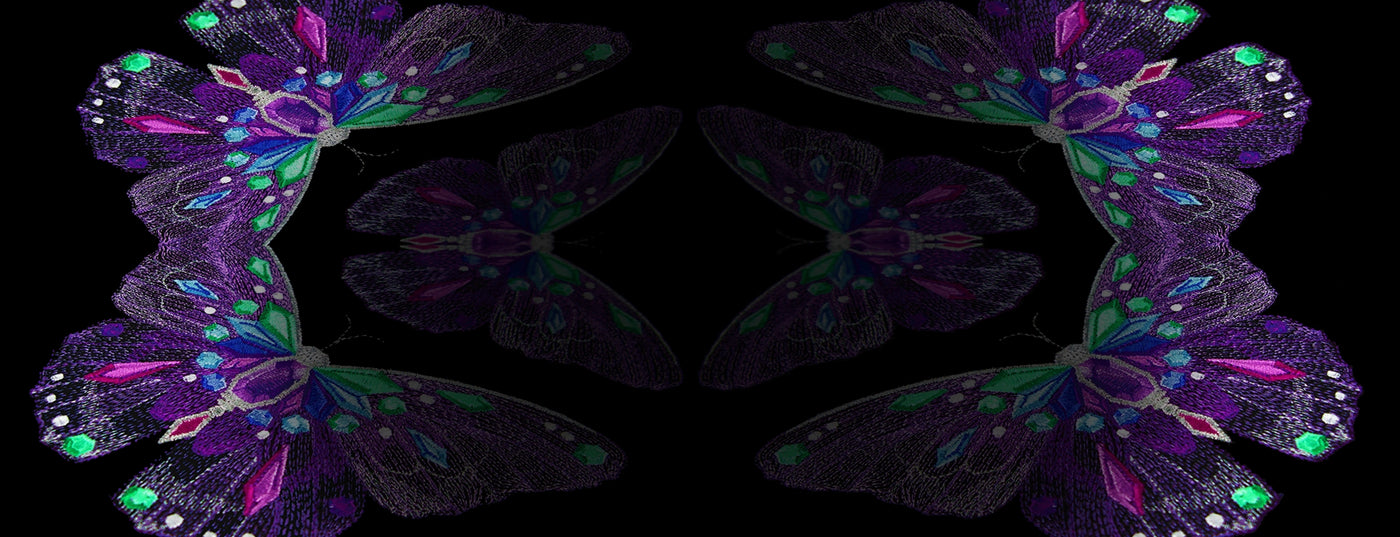 Colorful butterfly-like machine embroidered shapes on a black background