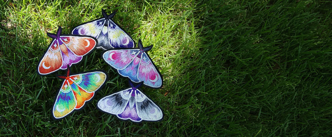 Machine embroidery freestanding moths on grass