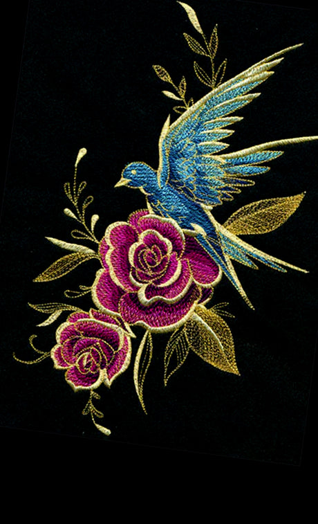 Machine embroidered design of a blue bird and pink roses on a black background