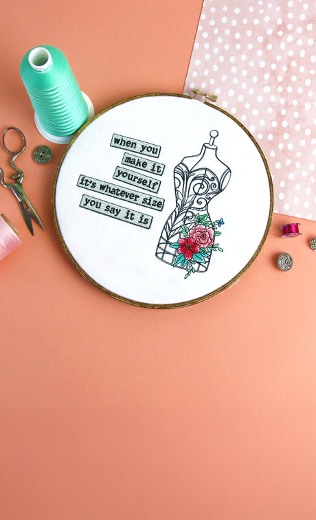 Machine embroidery make it yourself design in a hand embroidery hoop on a pink background