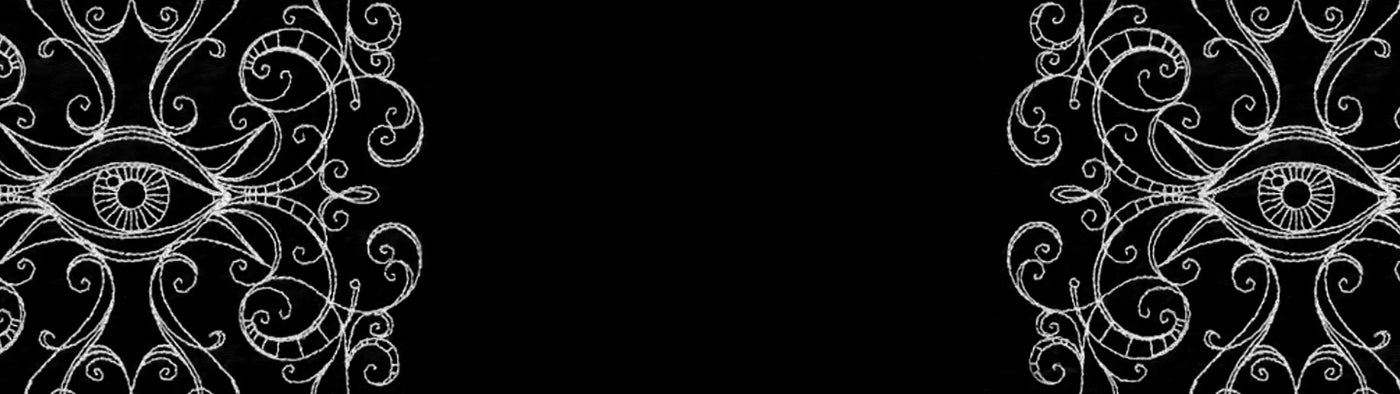 Decorative machine embroidery eye design with intricate patterns on a black background