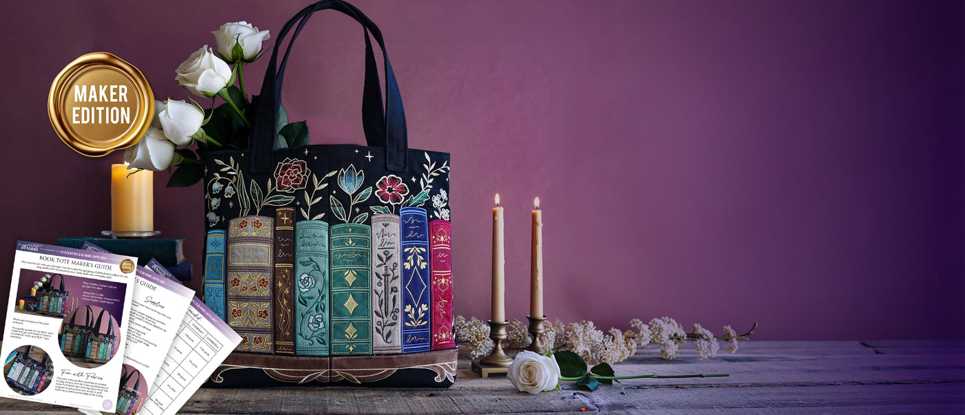 Decorative tote bag with machine embroidered applique book design on a wooden surface against a purple wall. Wax seal styled gold icon reads "maker edition".