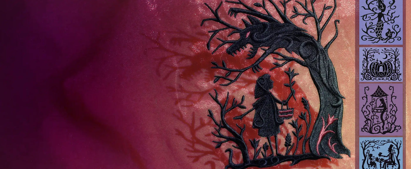 Machine embroidery fairytale designs on red and purple fabric.