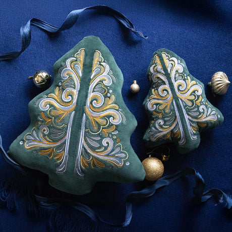 Two Christmas tree shaped pillow featuring machine embroidery designs