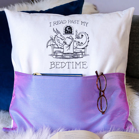 a reading pocket pillow featuring a machine embroidery design of a reading dragon