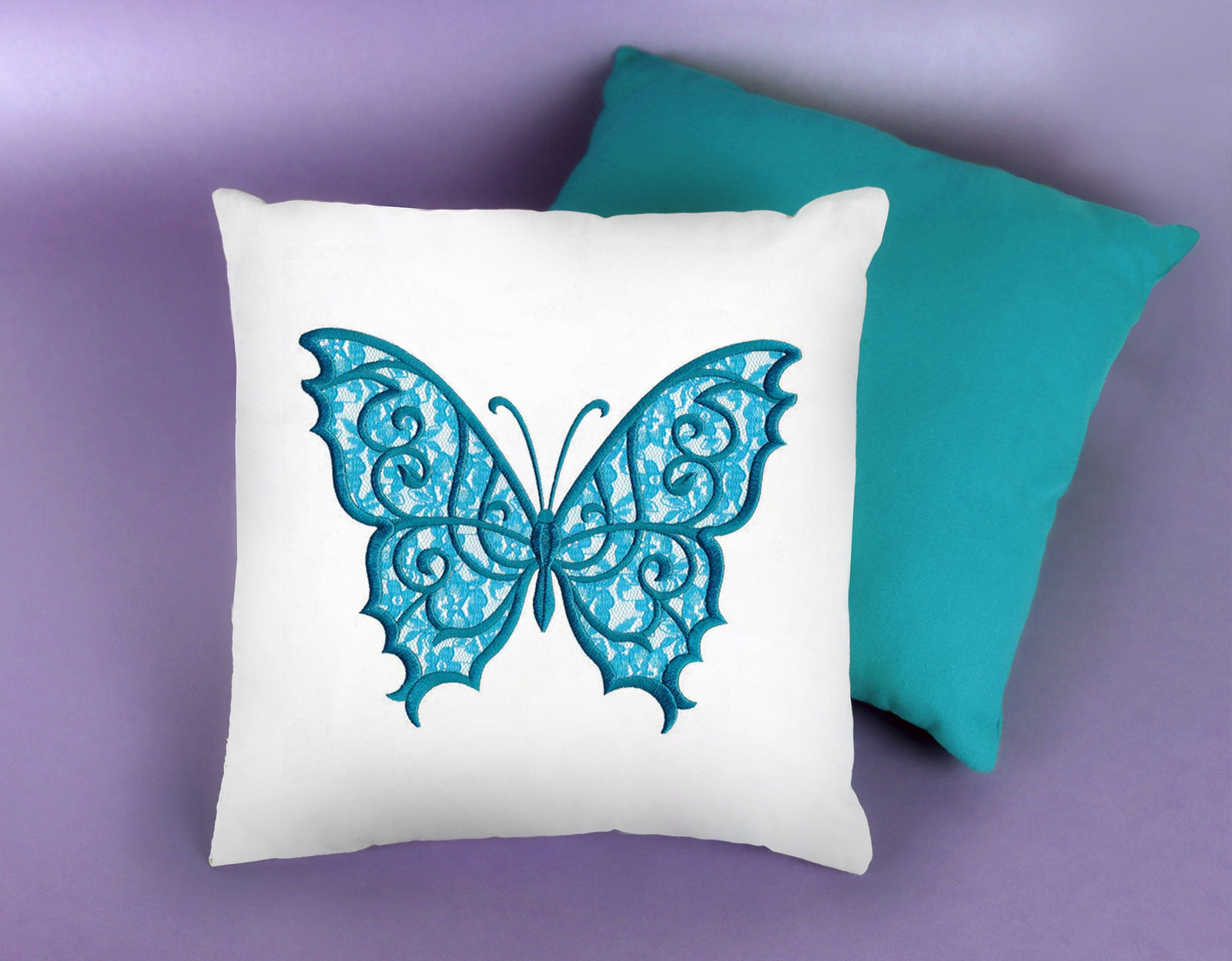 white pillow with a machine embroidery design of an applique butterfly