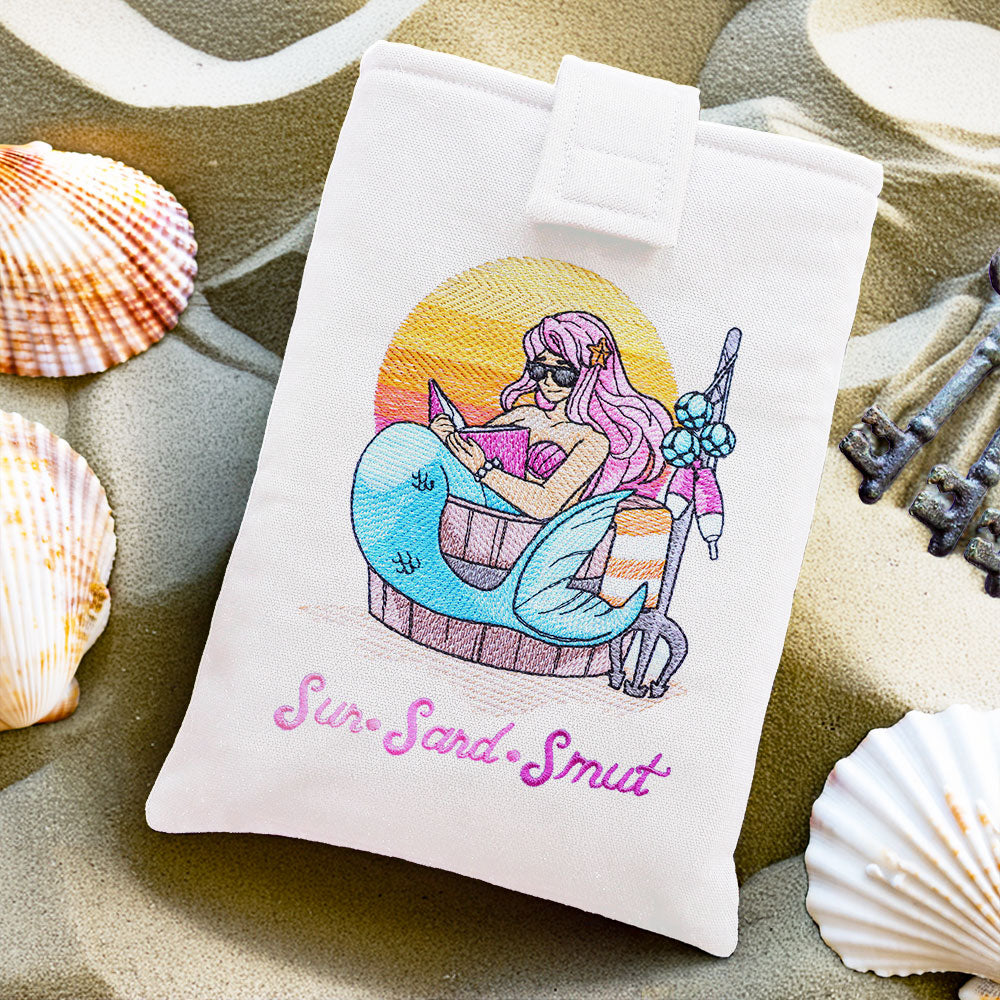 a machine embroidered book sleeve featuring a mermaid design