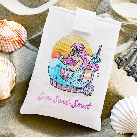 a machine embroidered book sleeve featuring a mermaid design