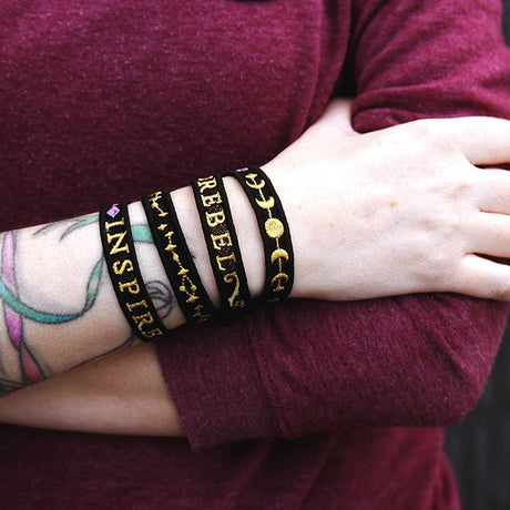 a stack of machine embroidered freestanding lace bracelets