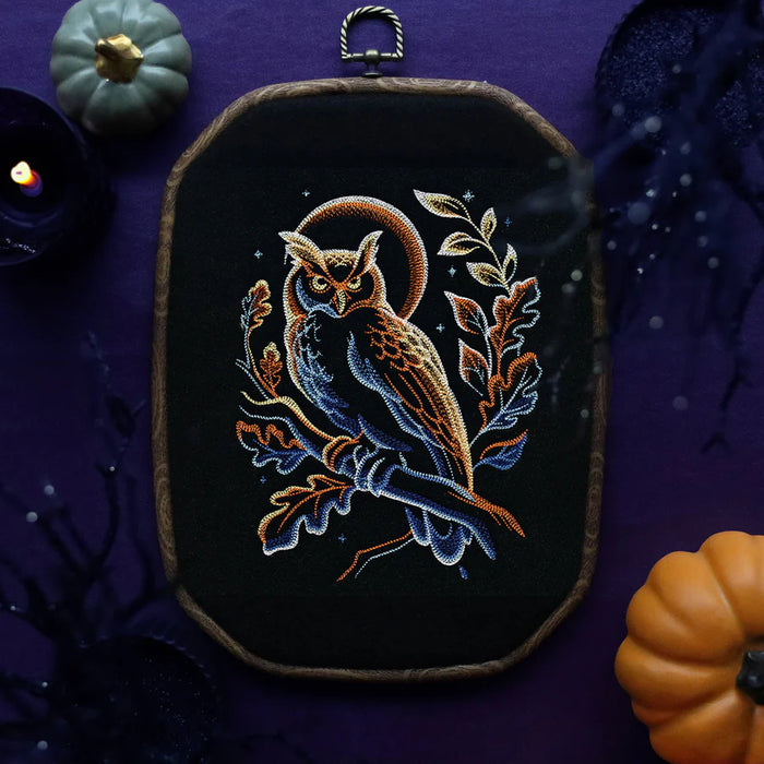 Embroidered owl design on a dark background with pumpkins and candles.