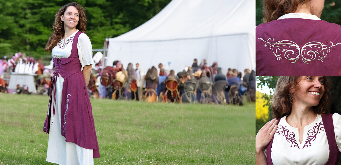 Woman in costume with embroidery detail in a grassy outdoor setting