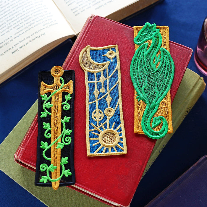 Decorative fantasy inspired lace bookmarks with intricate designs on a book