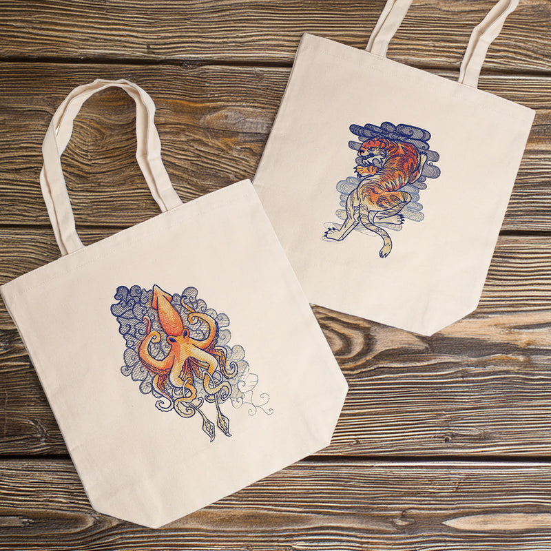 Two tote bags with animal designs on a wooden surface