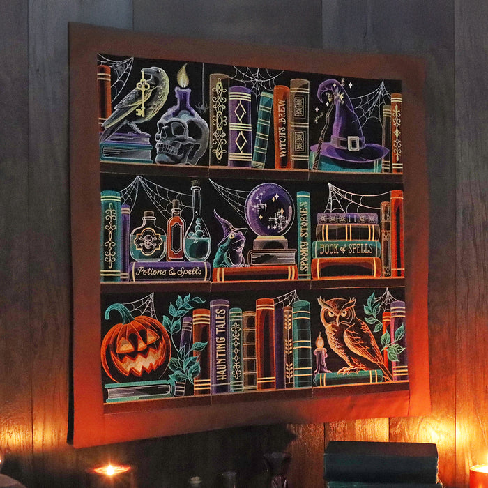 Decorative wall art with Halloween bookshelf themed panel designs on a dark background
