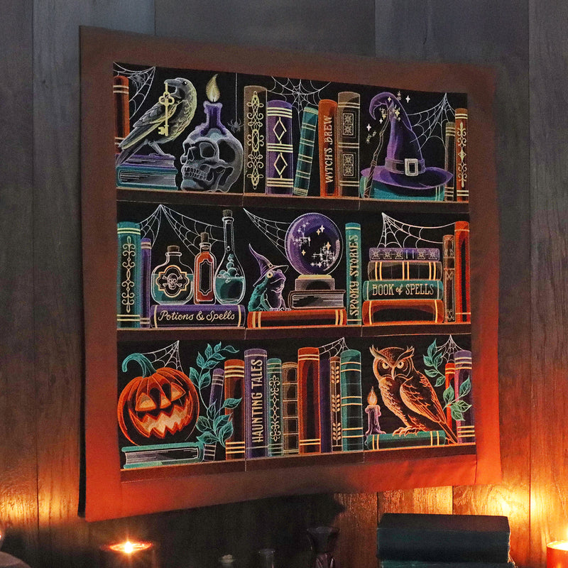 Decorative wall art with machine embroidery Halloween bookshelf themed panel designs on a dark background