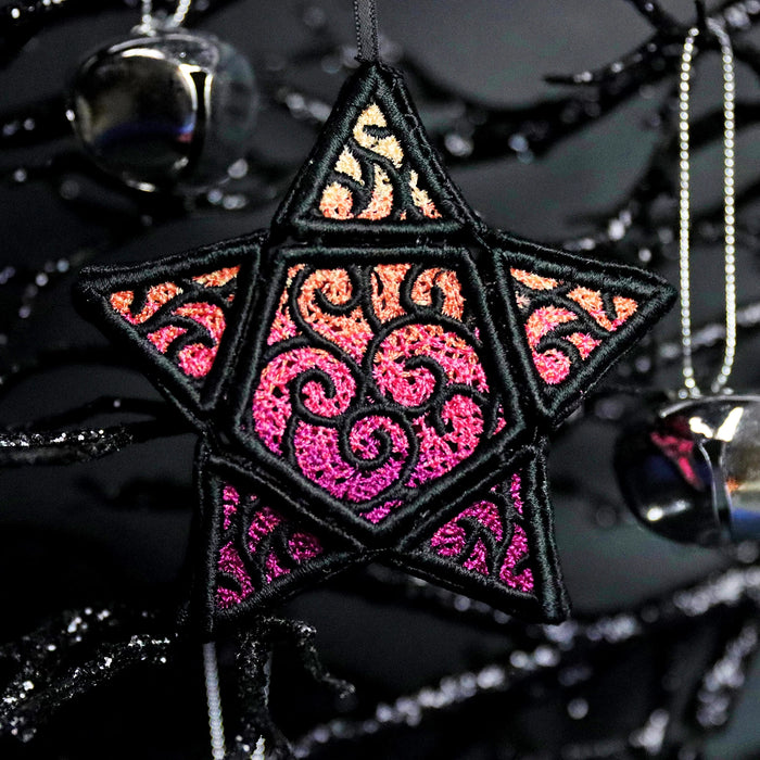 Machine embroidered 3D Lace star hanging on dark branches surrounded by bells.