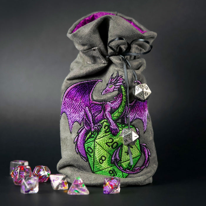Drawstring bag with a machine embroidered dragon with d20 dice surrounded by dice.