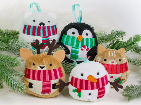 Set of machine embroidered Christmas-themed plushies including a bear, penguin, deer, cat, and snowman with scarves on a white background.