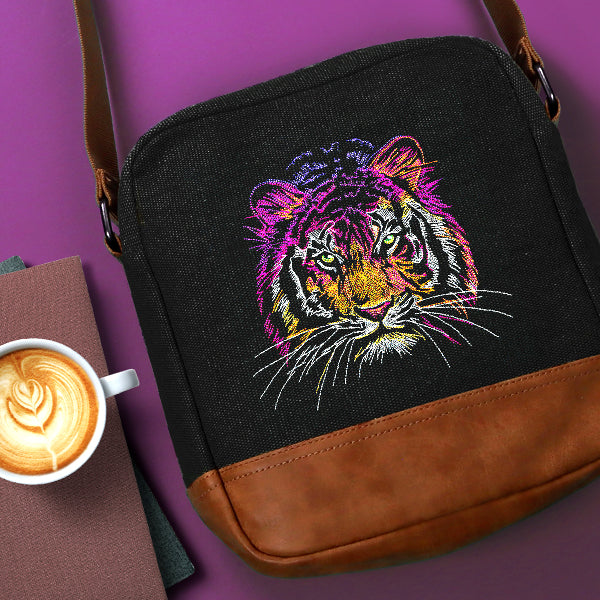 Black bag with a colorful machine embroidered tiger on a purple background