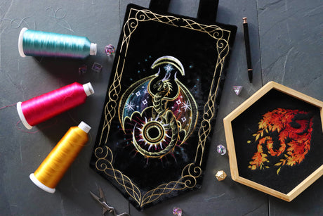 Machine embroidered celestial dragon on a black banner with a embroidered dragon on dice tray.