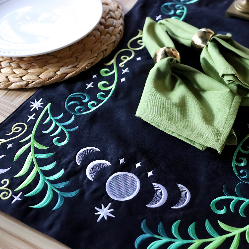 Digitally downloadable machine embroidery Design Pack with black runner featuring embroidered moons, stars, and vine motifs.