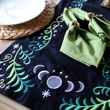 Digitally downloadable machine embroidery Design Pack with black runner featuring embroidered moons, stars, and vine motifs.