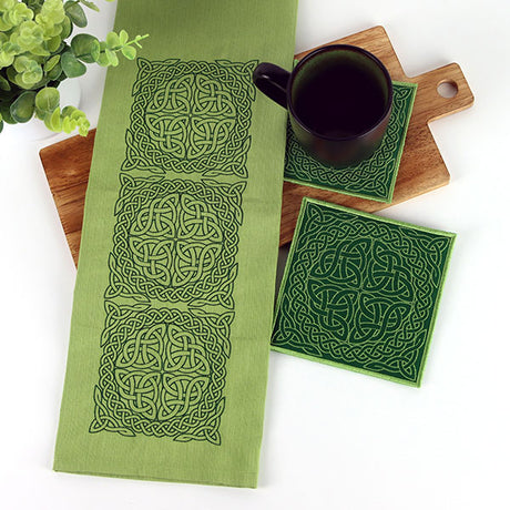 Celtic inspired machine embroidery designs on table runner and in-the-hoop coaster.