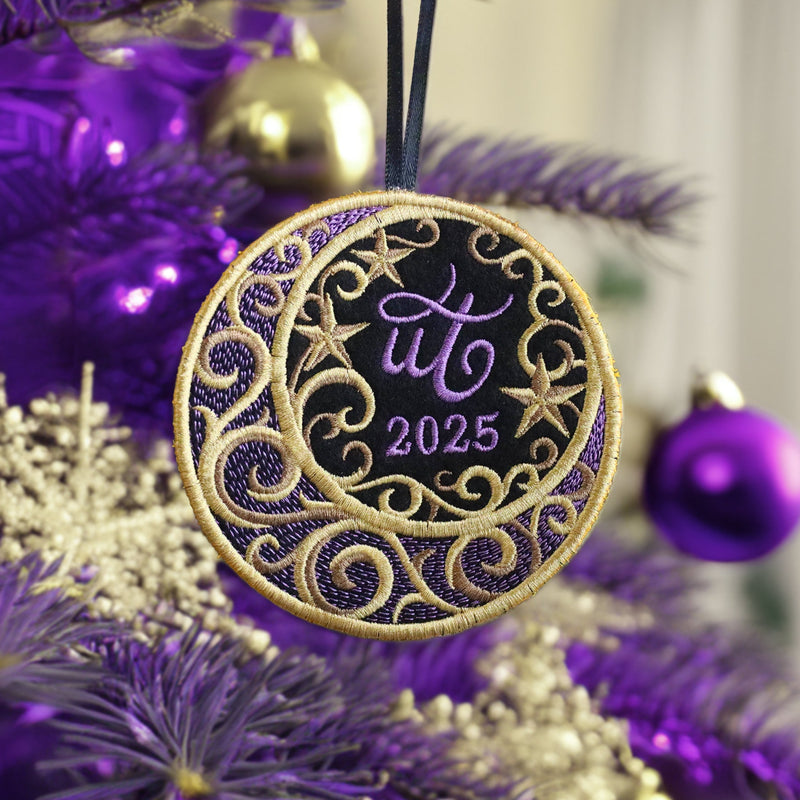 Decorative machine embroidery ornament with 'UT 2025' on a purple Christmas tree.