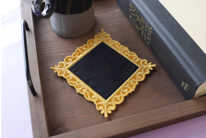 Gif of machine embroidery blank frame design with a crow design on a wooden tray.
