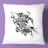 Embroidered leopard face with green eyes on a white base, digital machine embroidery design set against a purple background.