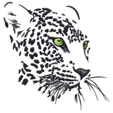 Black and white machine embroidery forms a leopard face with vivid green eyes on a white background, using negative space.