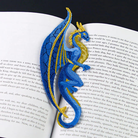 Machine embroidered freestanding dragon on an open book
