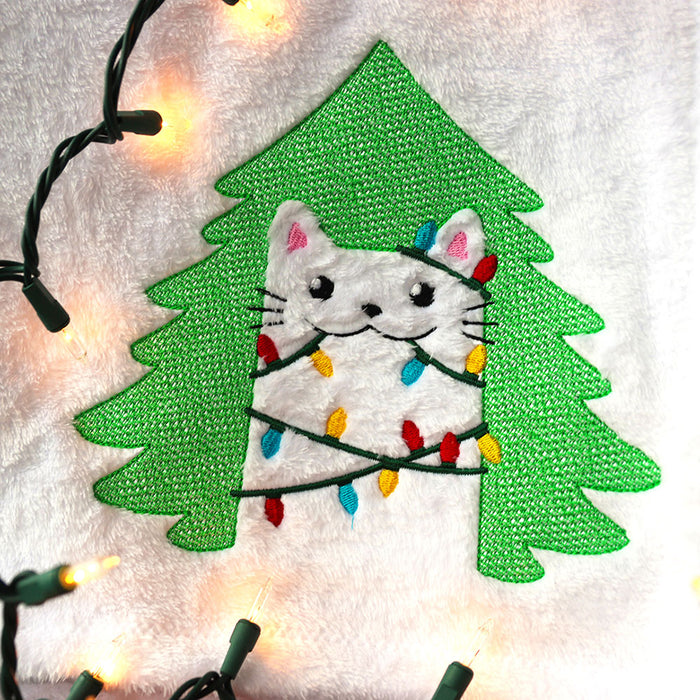 Machine embroidery design of an embossed Christmas cat on white fabric