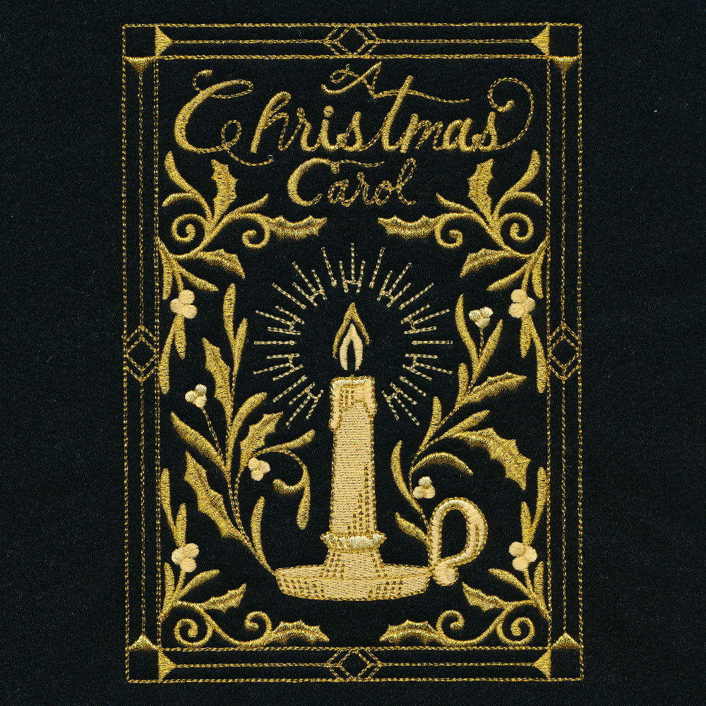 Embroidery of a golden candle with radiant light surrounded by holly leaves and berries, framed with decorative borders and text "A Christmas Carol" on black fabric.
