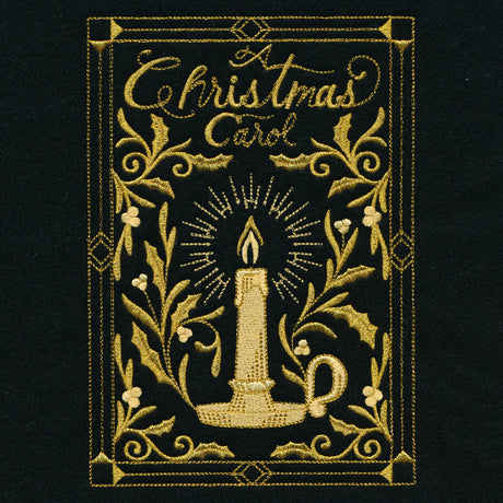 Embroidery of a golden candle with radiant light surrounded by holly leaves and berries, framed with decorative borders and text "A Christmas Carol" on black fabric.