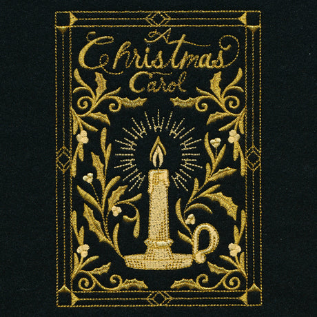 Gold embroidery on black fabric features a lit candle in a holder surrounded by decorative holly leaves and the words "A Christmas Carol" in ornate script.