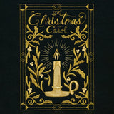 Gold embroidery on black fabric shows a candle in a holder surrounded by holly leaves and berries with the text "A Christmas Carol" framed by decorative borders.
