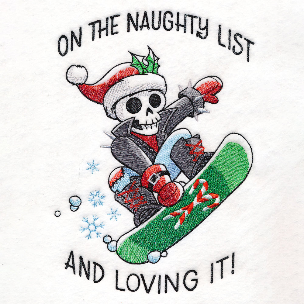 Embroidery of a skeleton wearing a red and white Santa hat, black jacket, red gloves, blue pants, and black boots snowboarding on a green board with candy canes, surrounded by snowflakes with the text "On the naughty list and loving it!" in black thread.