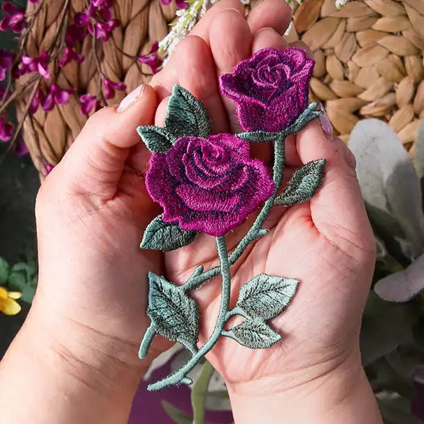 Hand holding a decorative machine embroidery freestanding flower.