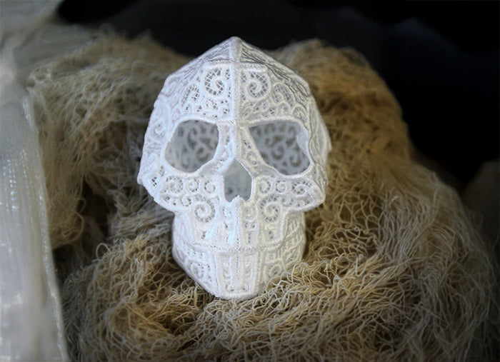 Decorative lace skull with intricate patterns on a textured surface