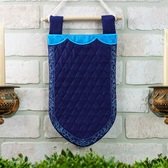 Animated gif of a blue machine embroidered wall hanging banner with a rotating display of different embroidery designs stitched in the middle.